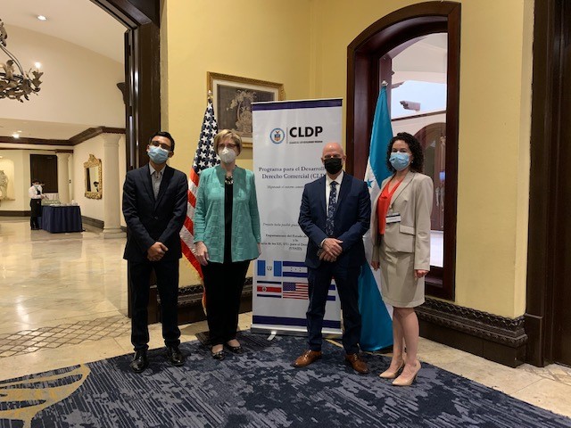 CLDP Attorney-Advisor shakes hands with the event's main speakers