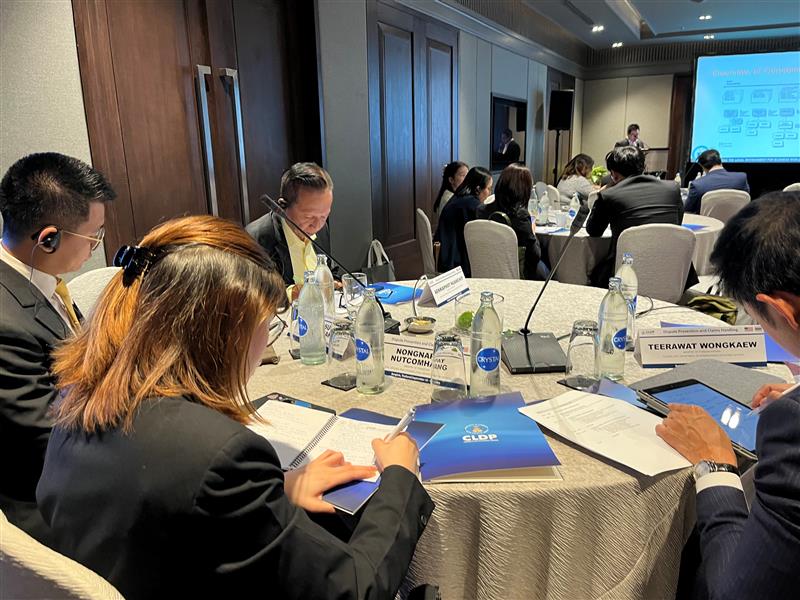 Participants taking notes during presentation