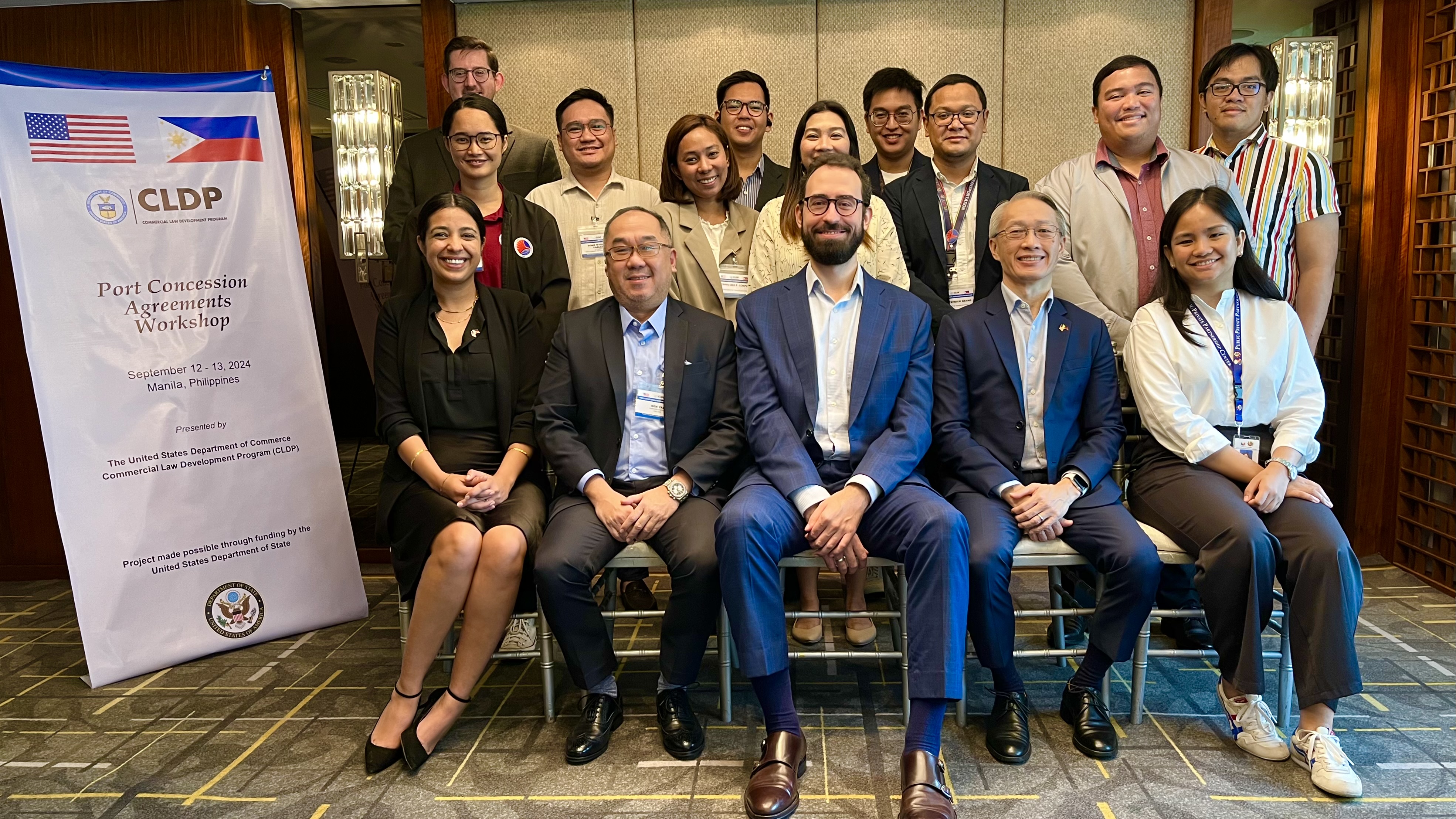Participants and Experts sitting in front of a large CLDP banner