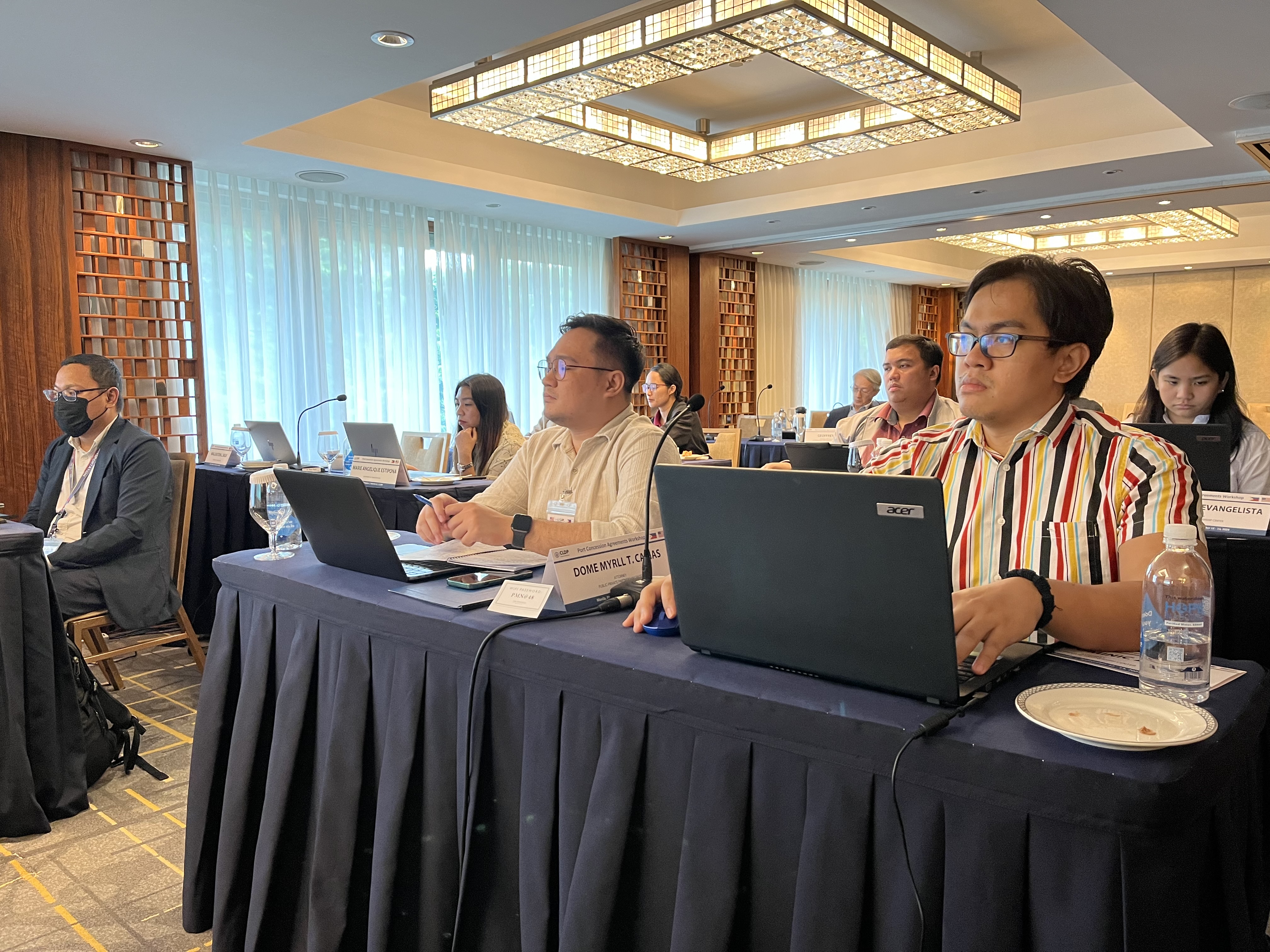 Participants in workshop listening and taking notes