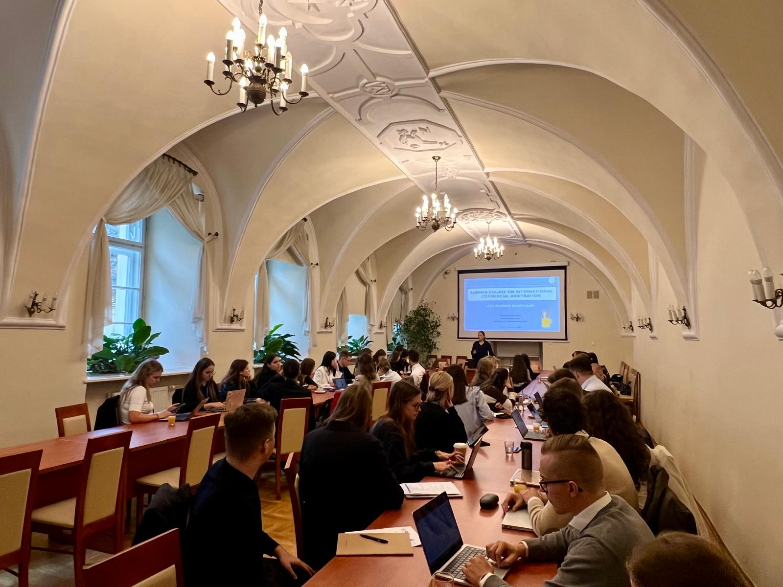 Summer Course students sitting at two long tables