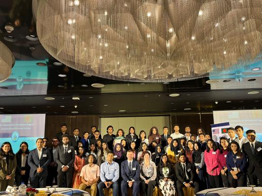 This is a group photo of participants in the Bangladesh Alternative Dispute Resolution workshop. There are three rows of people, consisting of 55 participants. In the front, there are five people seated.