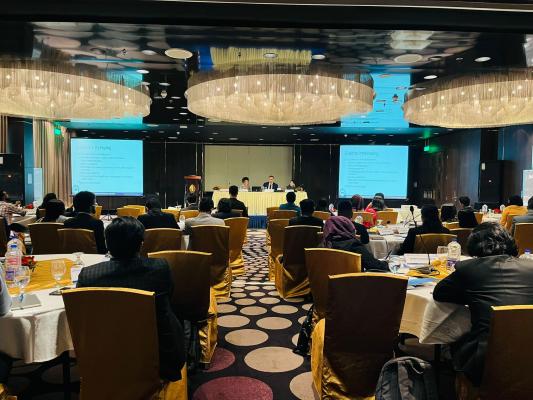 The photo is a banquet room with 55 participants