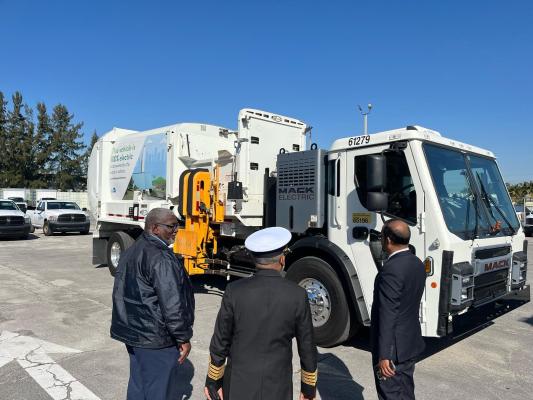 Group looking at modern dump truck