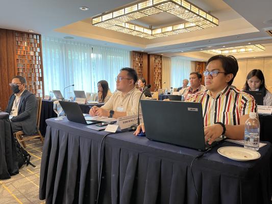 Participants in workshop listening and taking notes