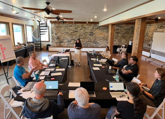 The authors seated around a table discussing the content of the handbook.