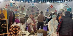 Artisan from Turkmenistan stands at the Central Asia Creativeworld 2023 booth